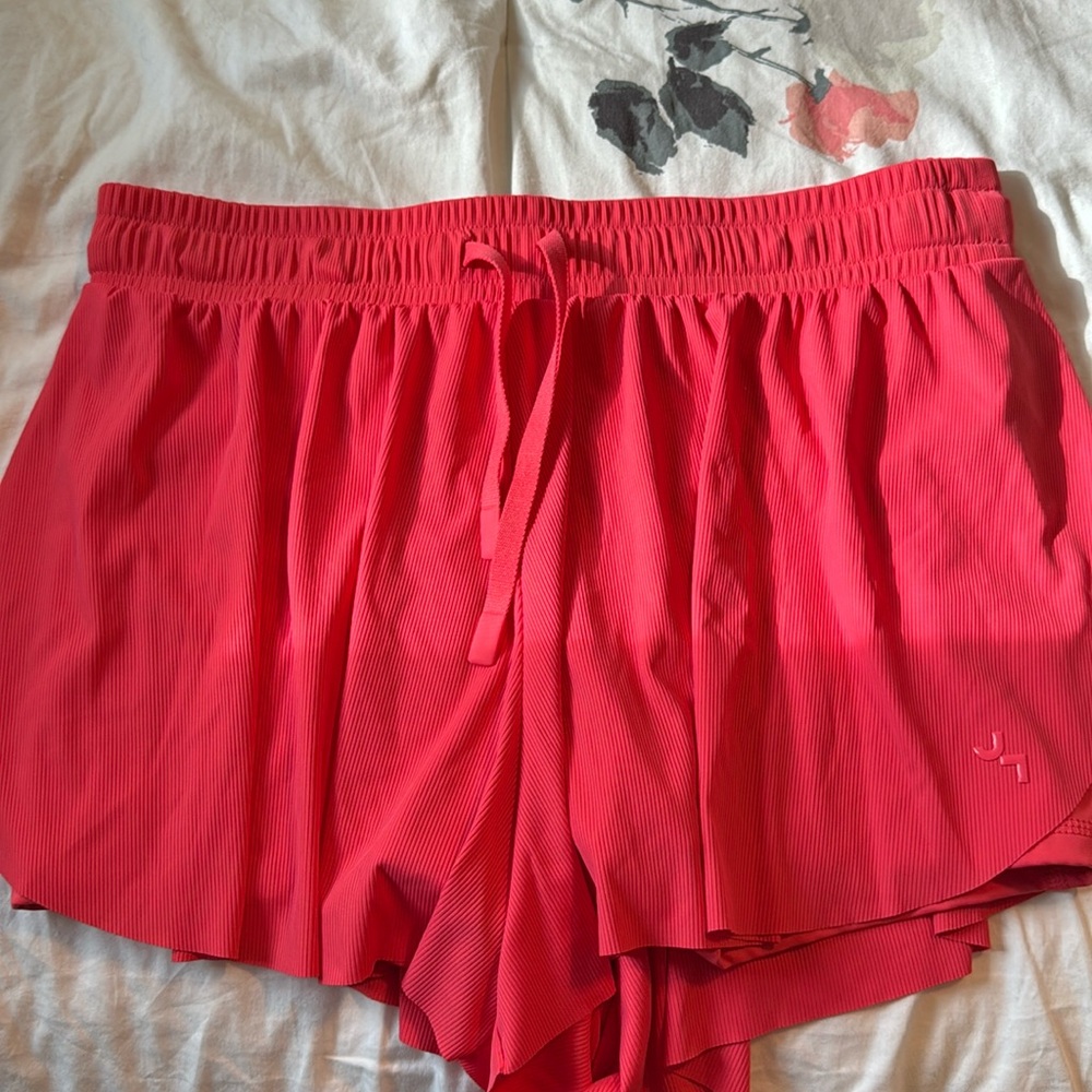 coral shorts, has pockets on each side,  flowy material